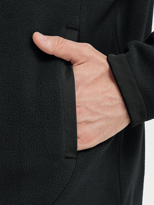 Hand in pocket detail of the Black Quarter Zip Polar Fleece Sweatshirt, soft fleece fabric.