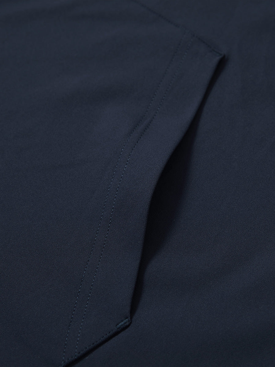 Close-up of single pocket detail on youth long sleeve hoodied with kangaroo pocket in navy, showing stitching.