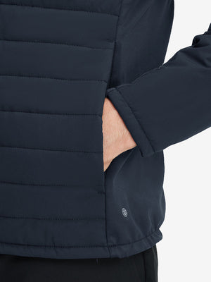 Detail view of outer pocket on navy warm puffer winter golf jacket