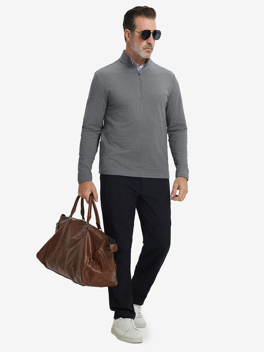 Model holding briefcase, dressed in casual fleece lined quarter zip pullover in grey, full-body view.