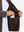Close-up of winter thermal outdoor water resistant fleece jacket pocket holding a phone, practical detail in coffee brown