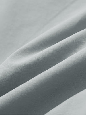 Close-up of rose dust boys lightweight dry fit flat front golf shorts fabric texture.