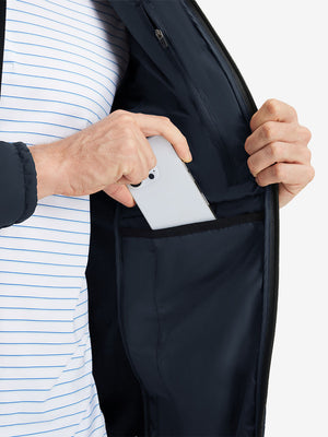 Detail view of inner pocket on navy warm puffer winter golf jacket