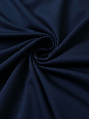 Close-up of navy premium performance polo fabric showing smooth texture.