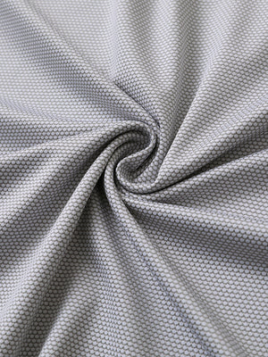 Close-up of grey white performance ananas jacquard polo fabric showing refined texture.