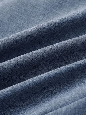 Close-up of dark blue heather performance golf shorts fabric showing breathable texture.