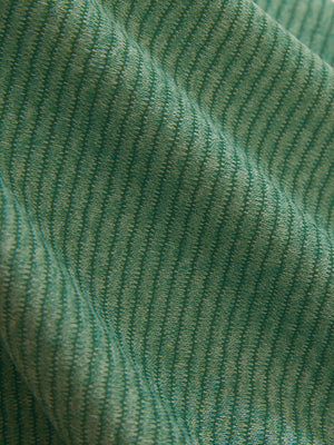 Close-up texture of light green featherweight midlayer quarter zip pullover fabric showing detailed lightweight material and weave.