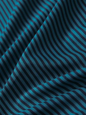 Close-up of turquoise performance cooling polo - youth fabric texture.