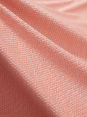 Close-up texture of orange red grid featherweight midlayer quarter zip pullover fabric showing detailed lightweight material and weave.