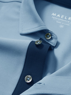 Detail shot of the collar on the misty blue ventilated pique performance polo, emphasizing the classic neckline design