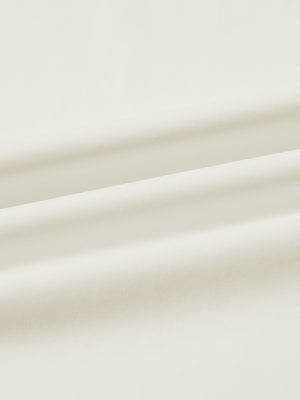 Close-up fabric detail of lightweight golf quarter zip pullover, smooth texture and breathable feel in cream