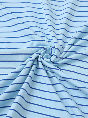 Close-up fabric view of youth performance golf polos, smooth texture with breathable light blue/cobalt stripe finish