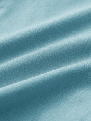 Close-up of sky blue heather performance golf shorts fabric showing moisture-wicking texture.