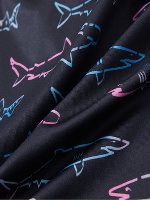 Close-up of ombre shark performance print boys golf polo, showcasing texture and print details.
