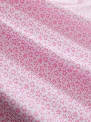 Fabric close-up of Performance quick dry print golf polos showing breathable texture in white pink floral