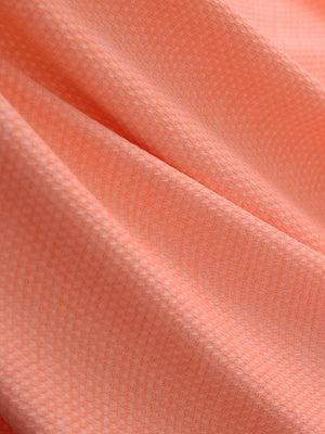 Close-up of orange red grid ultra-light quick dry moisture wicking collared polo shirt fabric texture