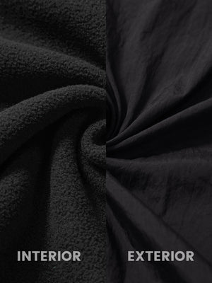 Close-up of inside and outside fabric of black windproof fleece reversible golf vest.