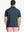 Rear half-body view showing fit and jacquard pattern of Ventilated Heather Jacquard Polo – JUNGLE GREEN HEATHER