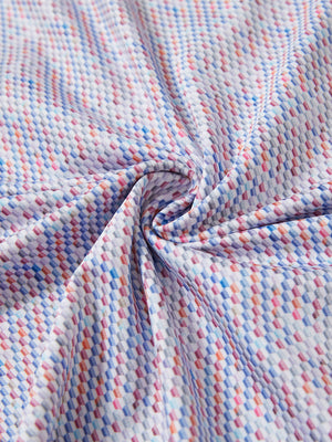 Close-up fabric detail of lightweight print long sleeve polo, breathable texture and soft feel in colourful hexagon