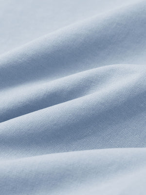 Macro view of the sky blue youth water resistant cotton blend golf pants fabric, showcasing the water repellent surface