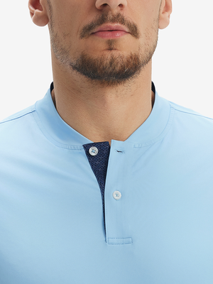 Close-up of model in light blue moisture-wicking short sleeve henley shirt, nose to chest front view.