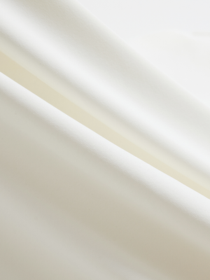 Close-up of cream Moisture-Wicking Short Sleeve Henley Shirt fabric texture.