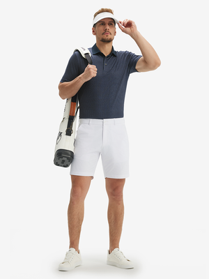 Full front: model in dark blue windmill lightweight stretch upgraded print golf polo shirts carrying golf bag.